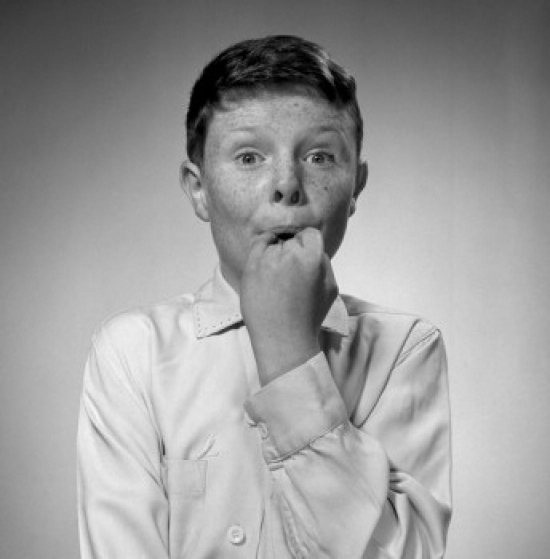 Portrait of freckled boy holding hand in mouth Canvas Art -  (24 x 36)