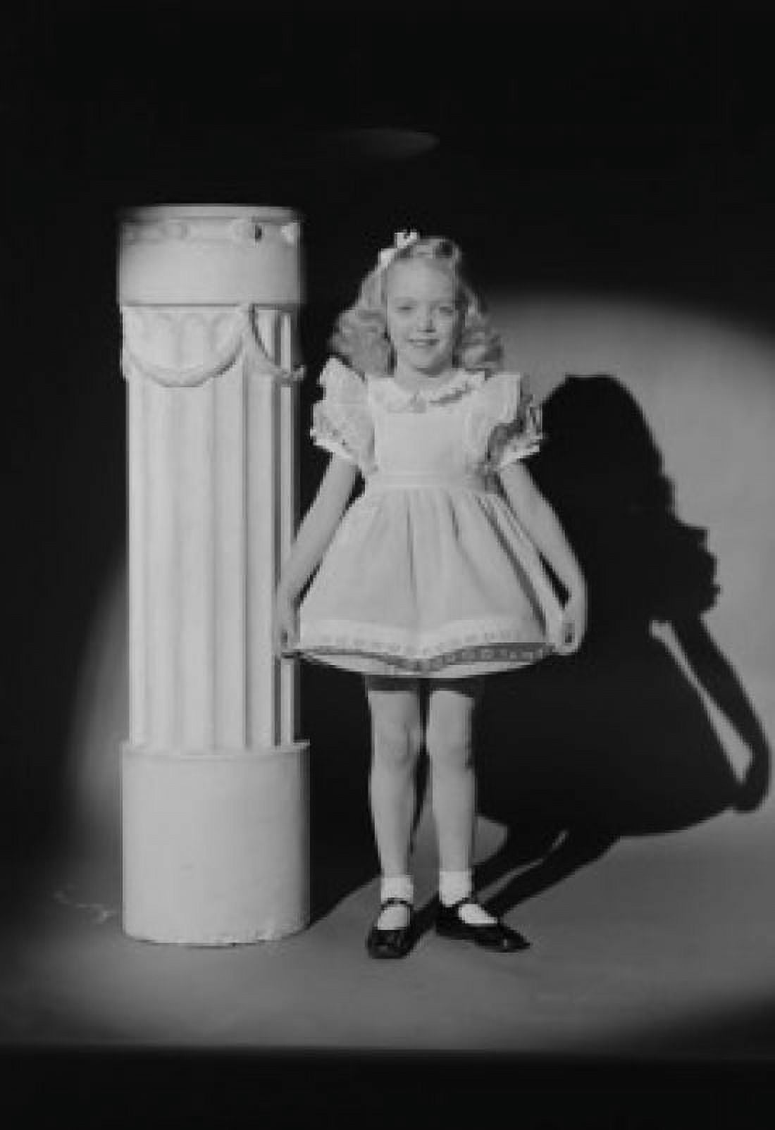 Portrait of girl in smart dress standing by column in spot light Canvas Art - (18 x 24)