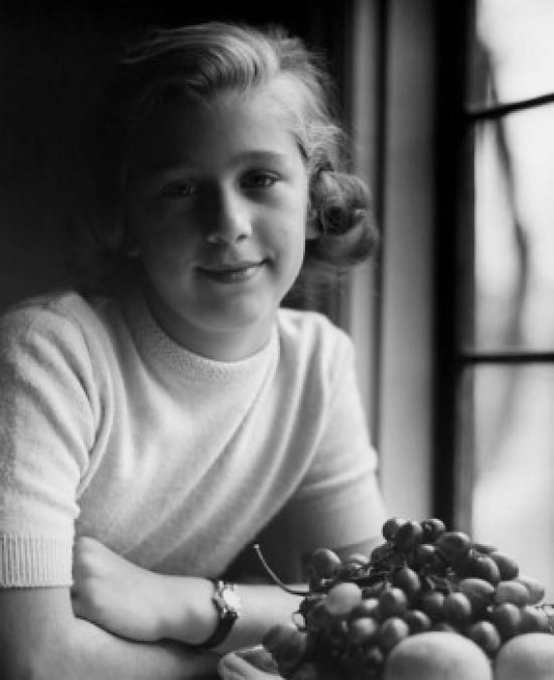 Portrait of girl sitting by window with plate of fruits Canvas Art - (24 x 36)