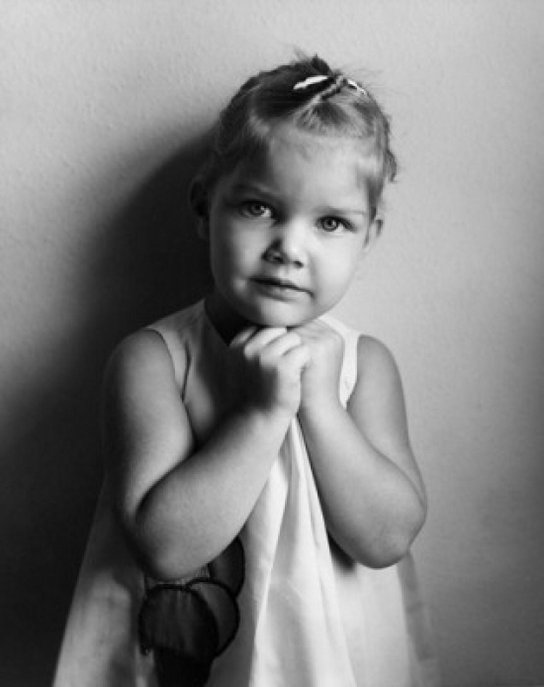 Portrait of little girl with hands under chin Canvas Art - (24 x 36)