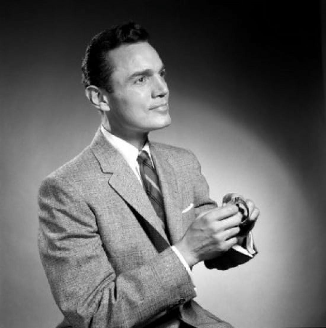 Portrait of man in suit looking up and winding up wristwatch Canvas Art -  (18 x 24)
