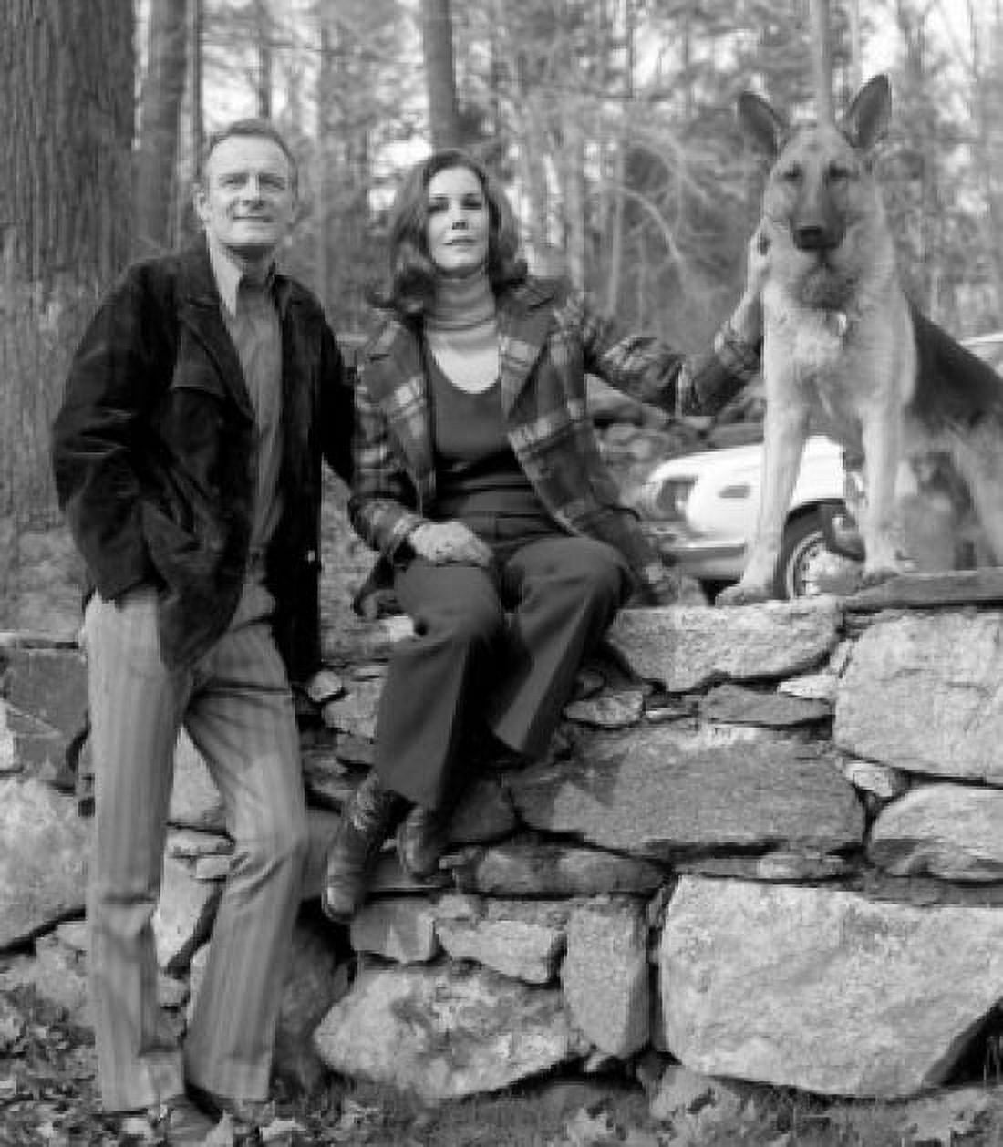 Portrait of mature couple with dog sitting on stone wall Canvas Art - (24 x 36)