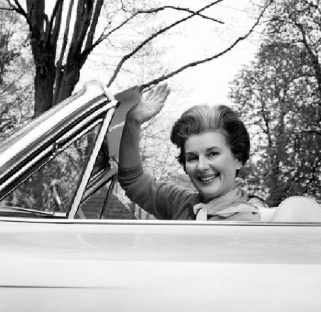 Portrait of mature woman sitting in car waving Canvas Art - (24 x 36)