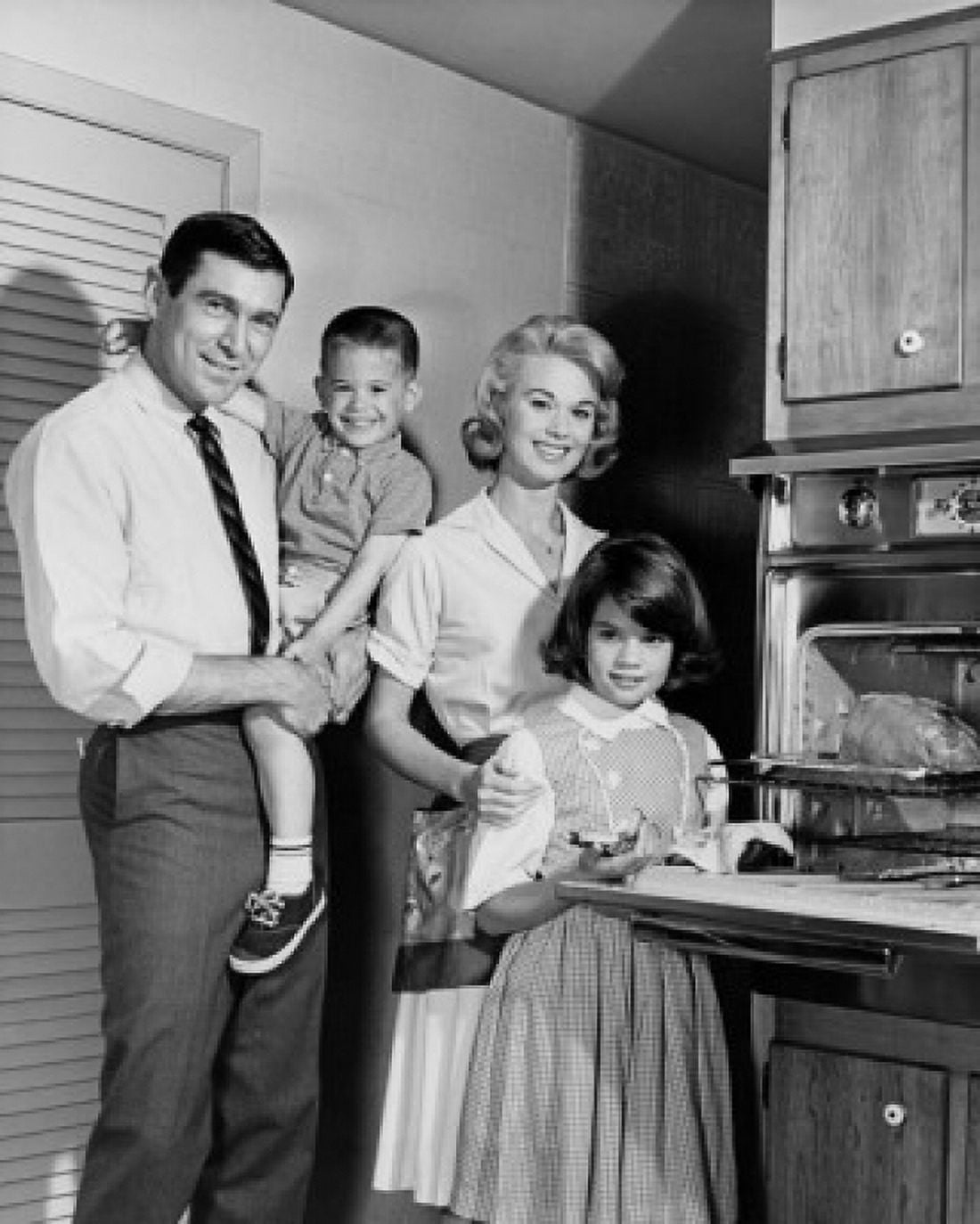 Portrait of parents and their children standing in a kitchen Canvas Art - (18 x 24)