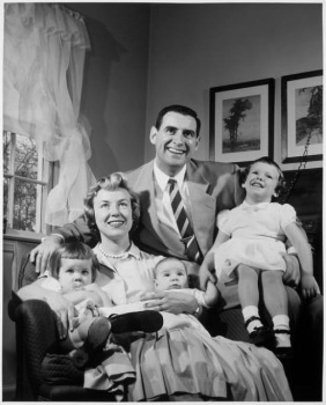Portrait of parents with three children sitting in living room Canvas Art - (24 x 36)