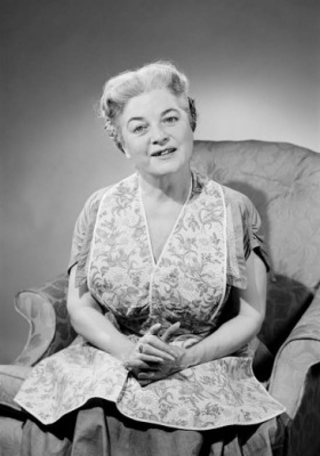 Portrait of senior woman sitting in armchair studio shot Canvas Art - (24 x 36)