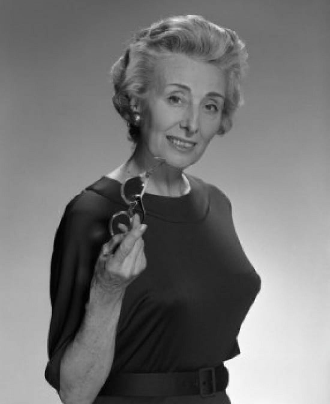 Portrait of smiled old woman holding glasses studio shot Canvas Art - (24 x 36)