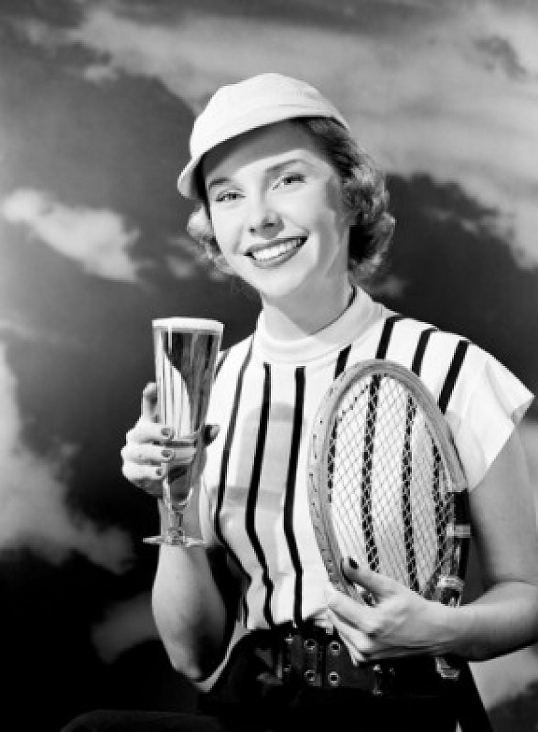 Portrait of smiling woman holding champagne and tennis racket Canvas Art - (18 x 24)