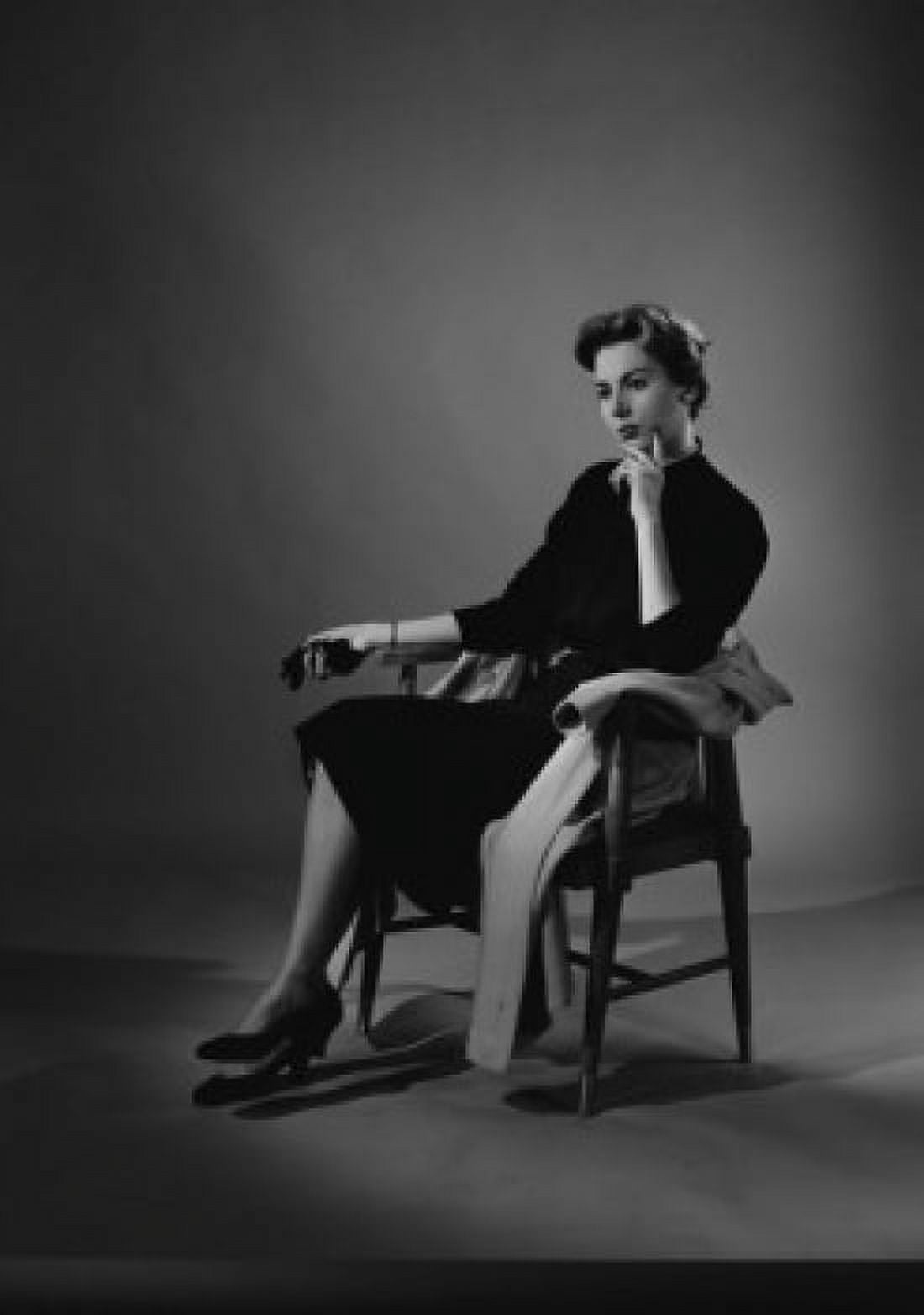 Portrait of thoughtful young woman sitting at chair studio shot Canvas Art - (24 x 36)