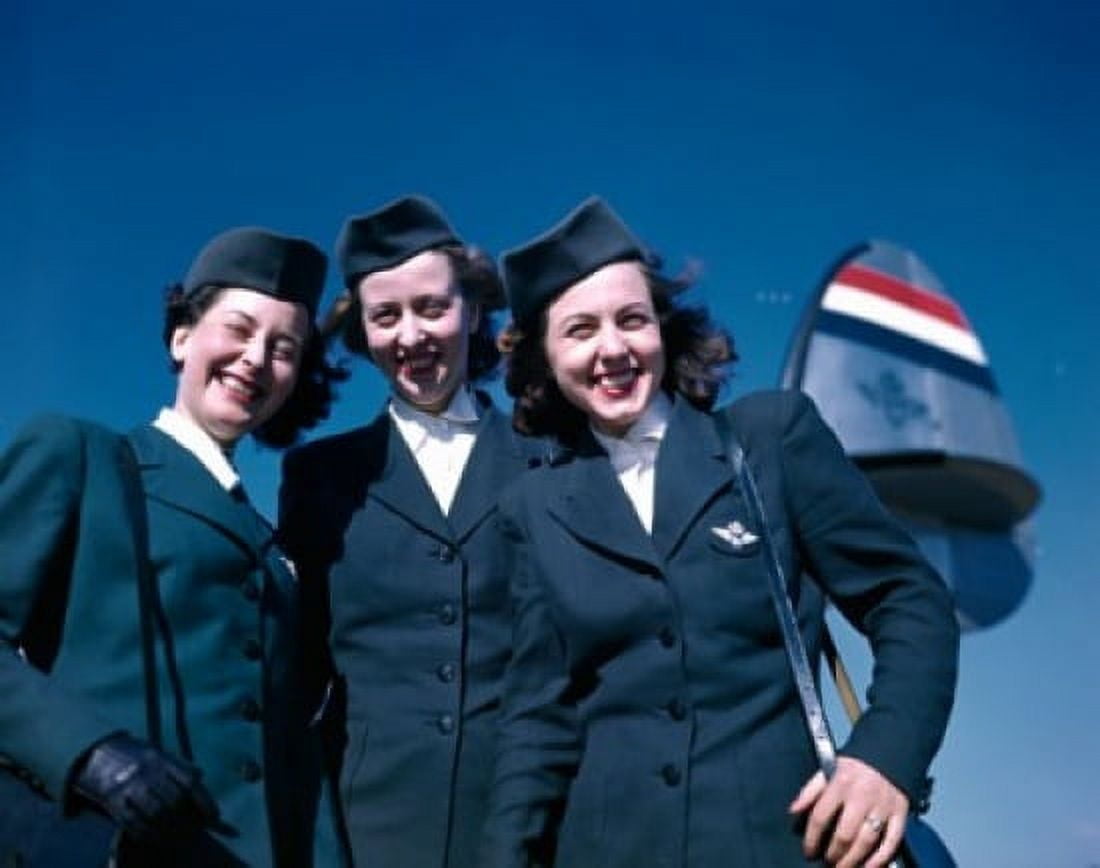 Portrait of three of three female cabin crew members standing near airplane against blue sky Canvas Art - (18 x 24)