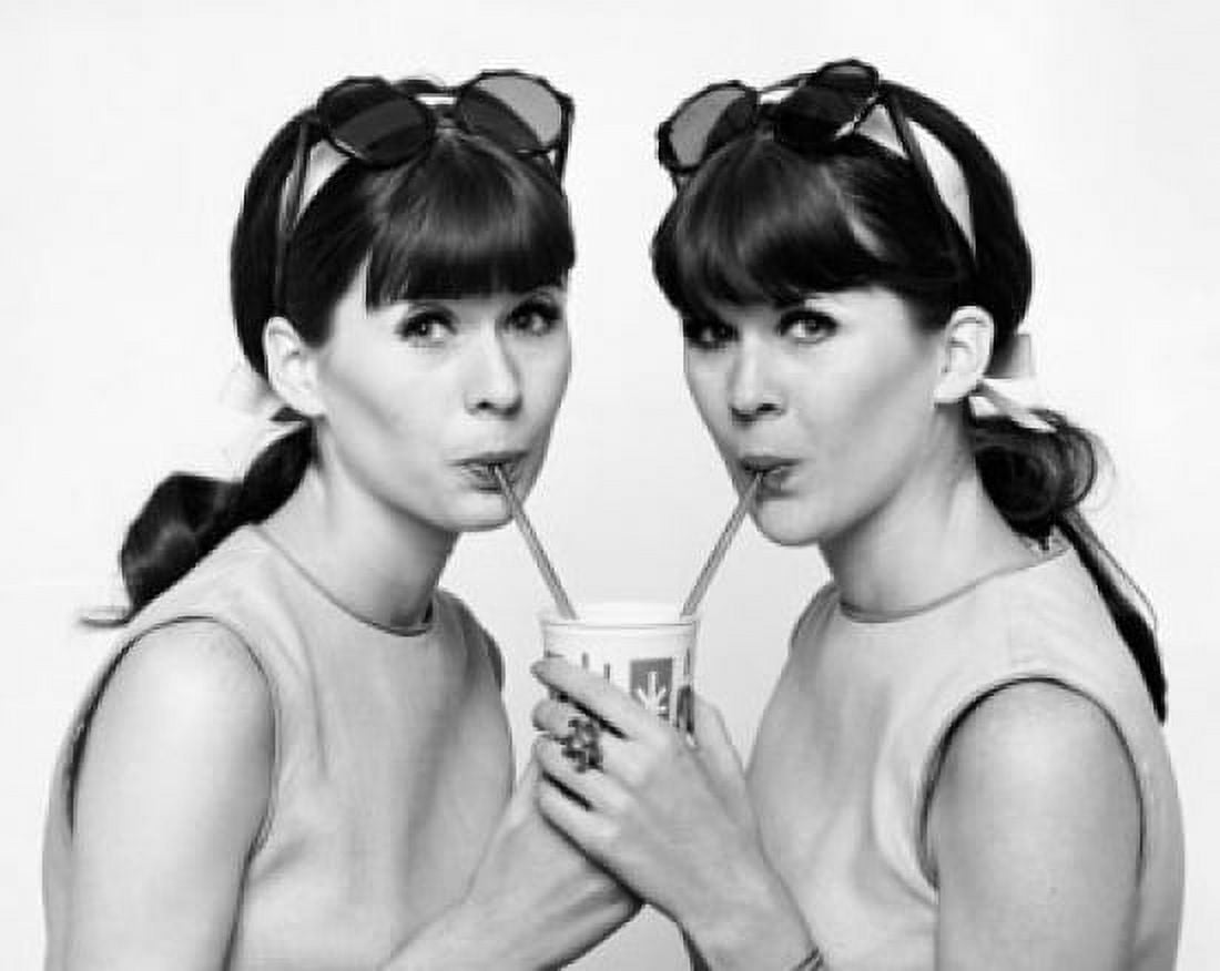 Portrait of twin young women drinking cold drink Canvas Art - (24 x 36)