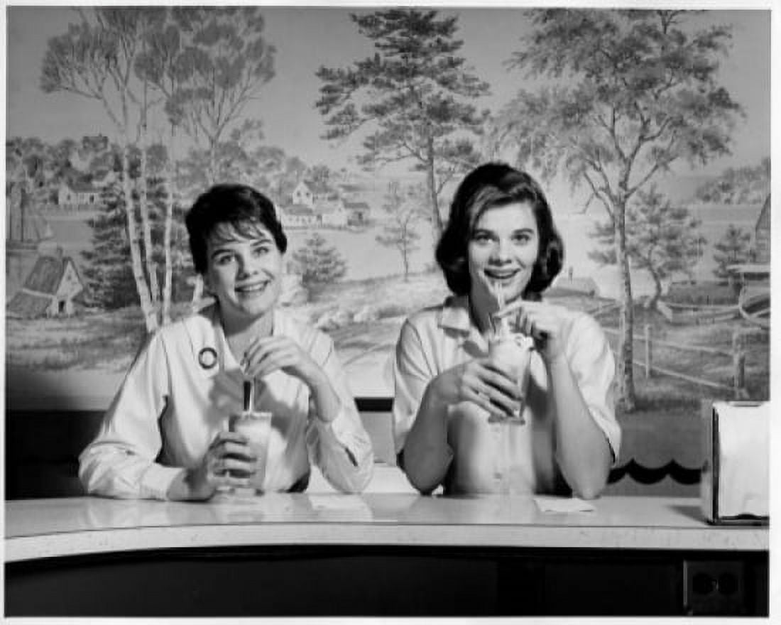 Portrait of two young women sitting in a restaurant Canvas Art - (24 x 36)