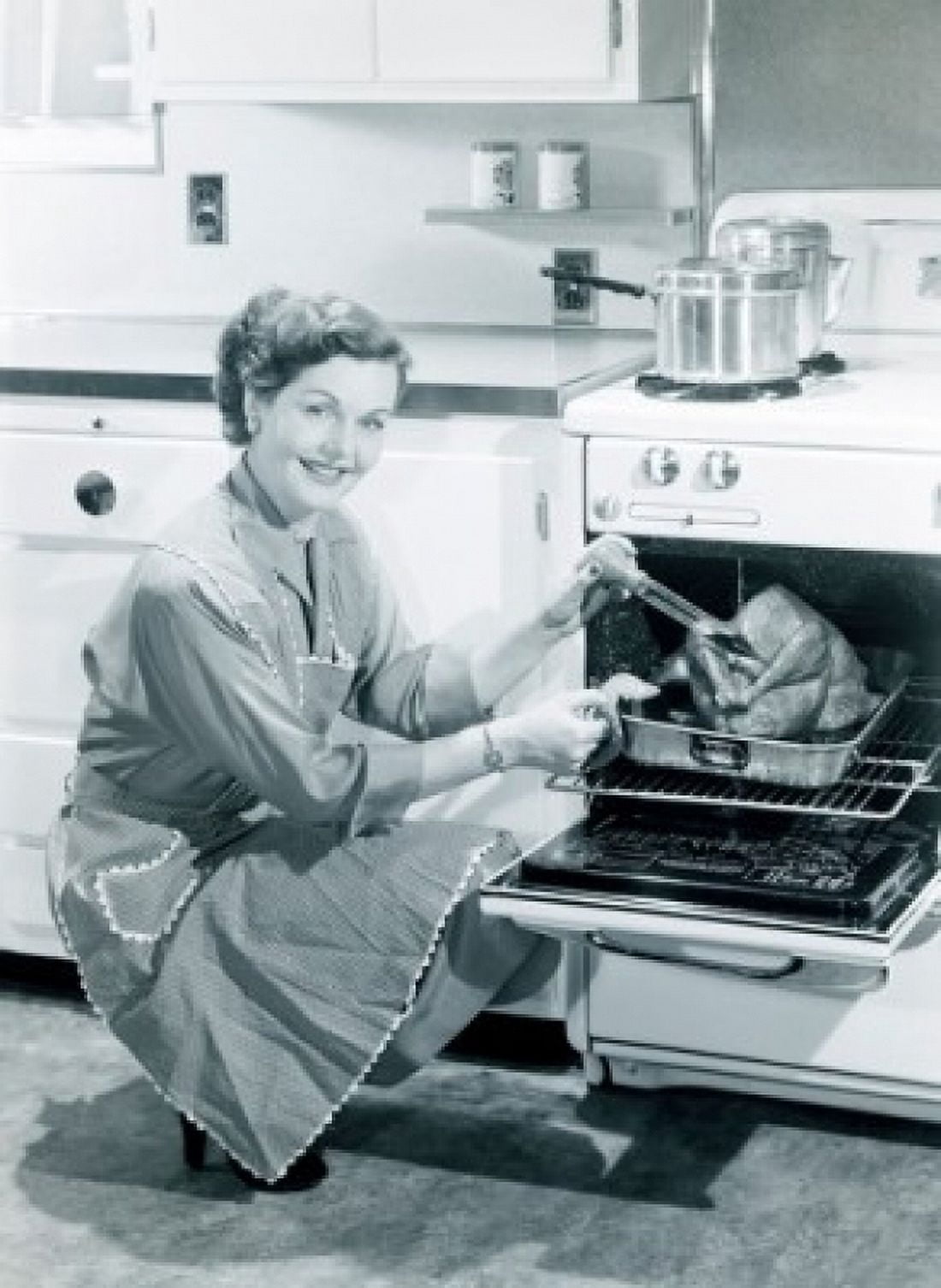 Portrait of woman cooking turkey in oven Canvas Art - (18 x 24)
