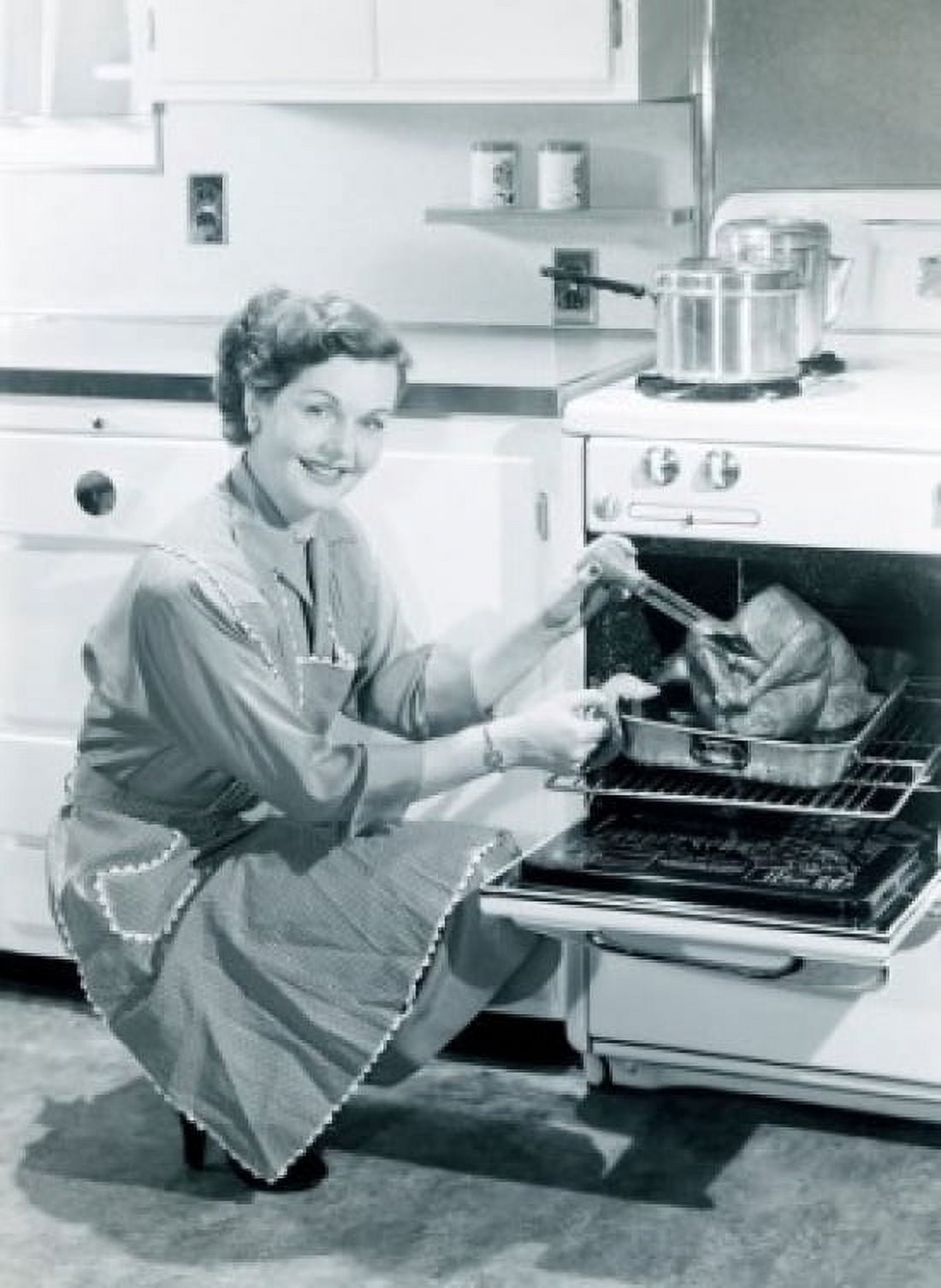 Portrait of woman cooking turkey in oven Canvas Art - (24 x 36)