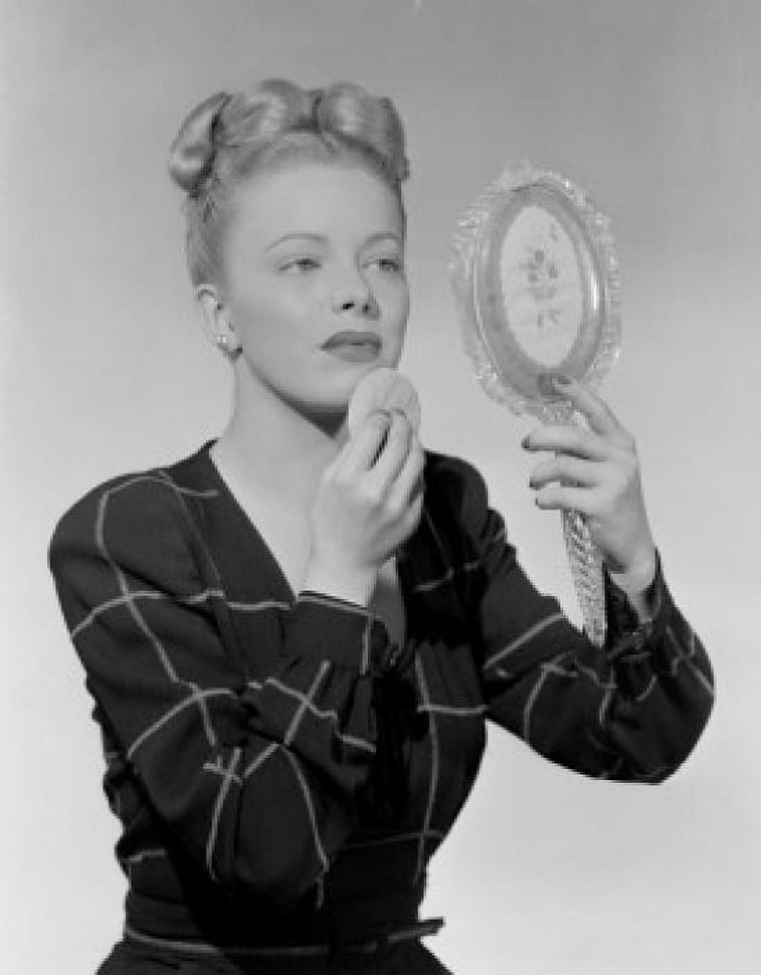 Portrait of woman looking at mirror and using powder puff Canvas Art - (18 x 24)