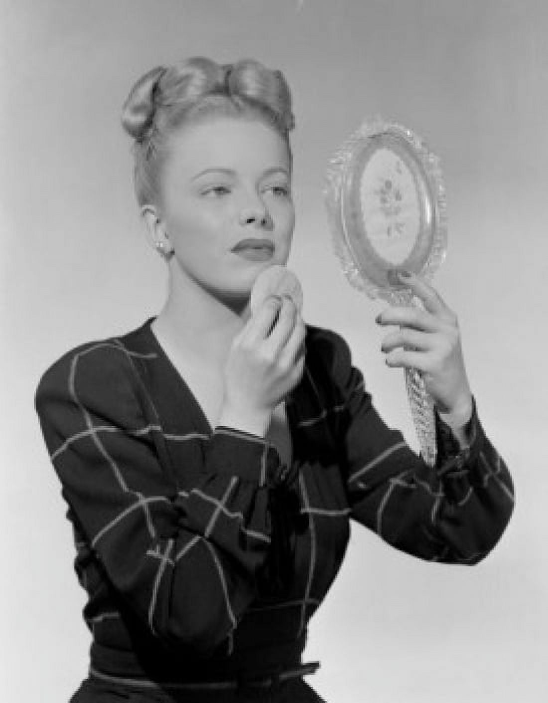 Portrait of woman looking at mirror and using powder puff Canvas Art - (24 x 36)