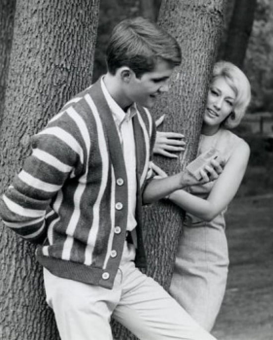 Portrait of young man holding radio and young woman hugging tree trunk Canvas Art - (24 x 36)