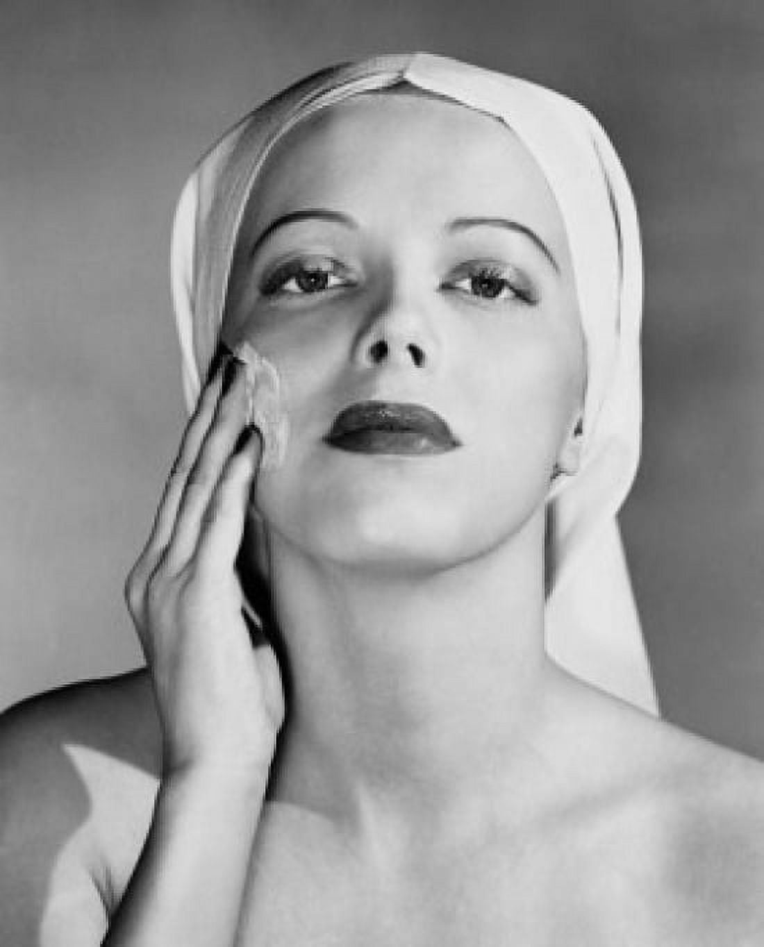 Portrait of young woman applying cream to her face Canvas Art - (24 x 36)
