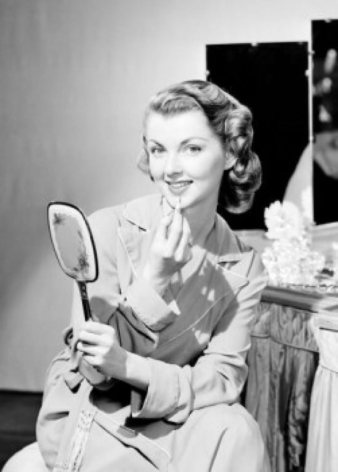 Portrait of young woman applying makeup Canvas Art - (18 x 24)