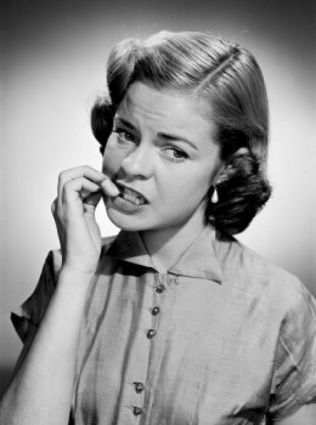 Portrait of young woman biting nails Canvas Art - (18 x 24)