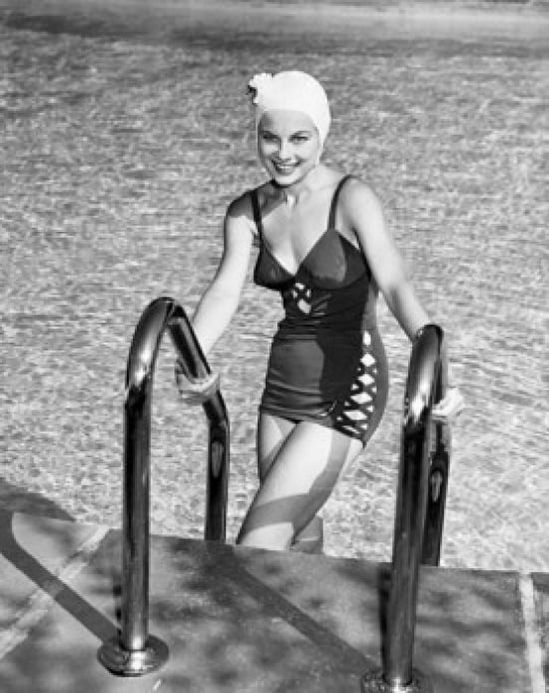 Portrait of young woman climbing ladder of swimming pool Canvas Art - (18 x 24)