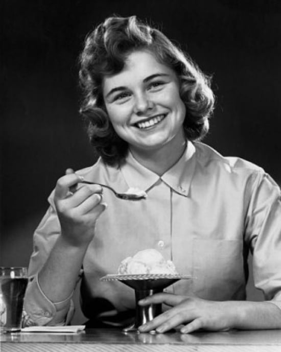 Portrait of young woman eating ice-cream Canvas Art - (18 x 24)
