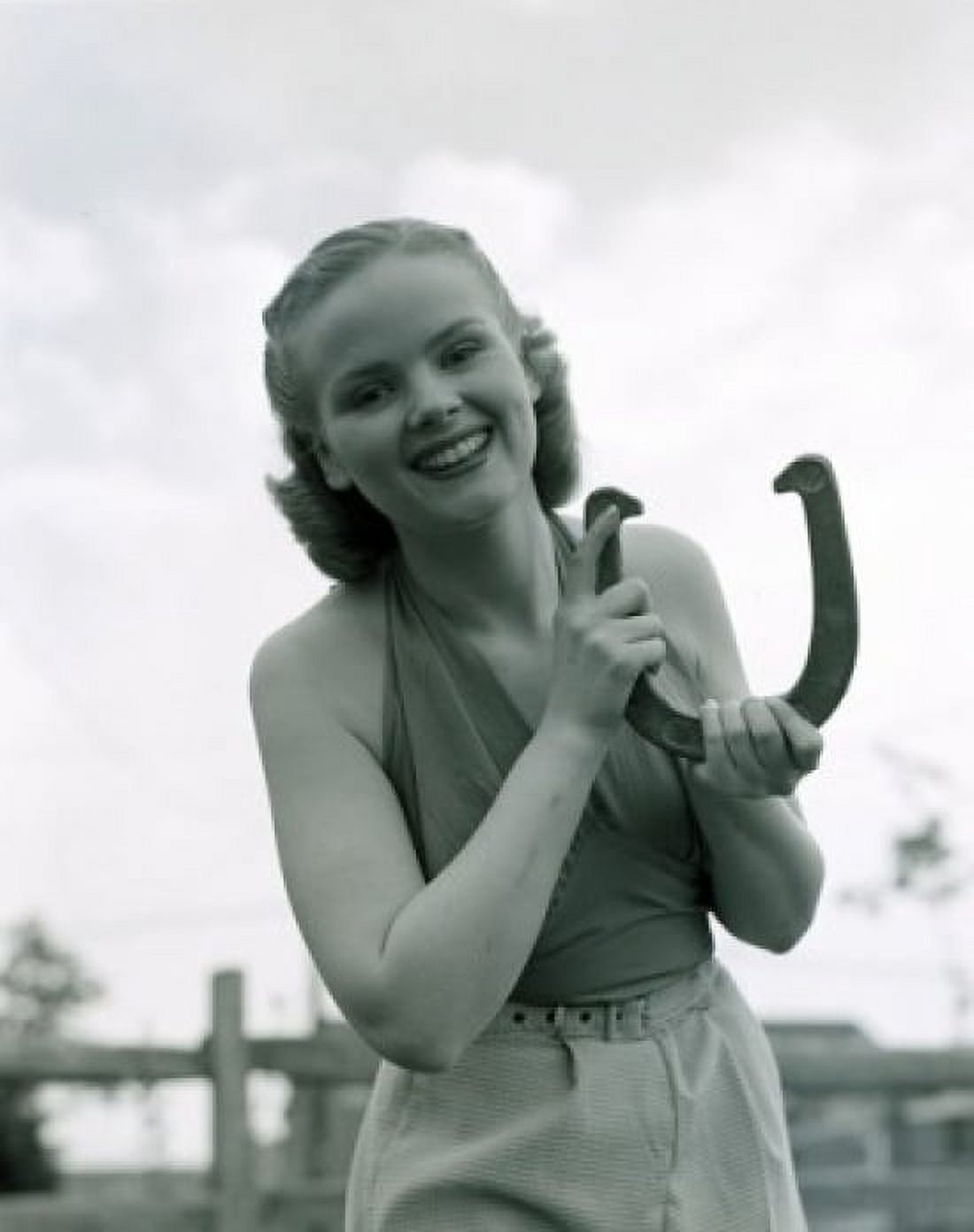Portrait of young woman holding horse shoe outdoors Canvas Art - (18 x 24)