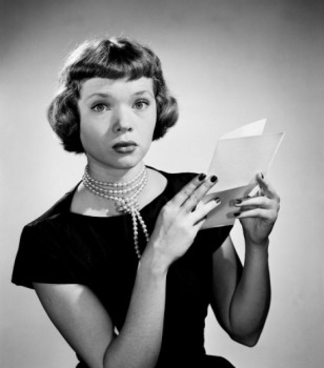 Portrait of young woman holding letter Canvas Art - (24 x 36)