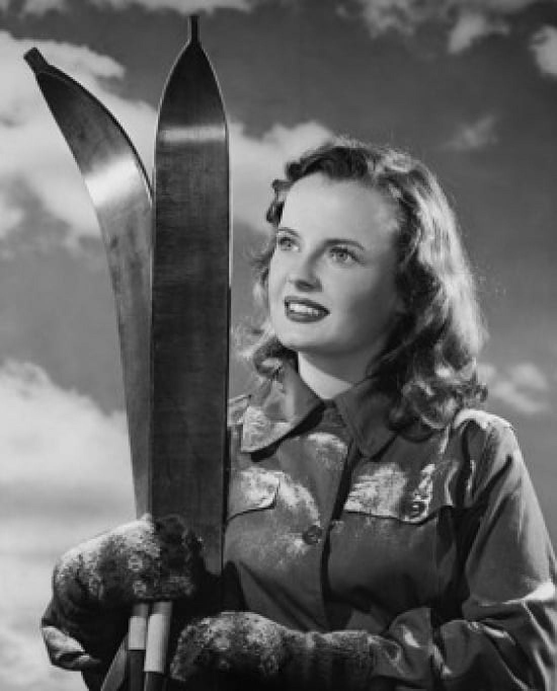 Portrait of young woman holding skis and smiling Canvas Art - (24 x 36)
