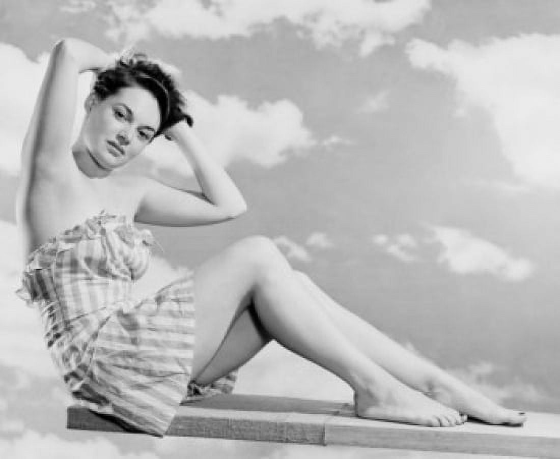 Portrait of young woman in swimsuit sitting on diving board Canvas Art - (18 x 24)