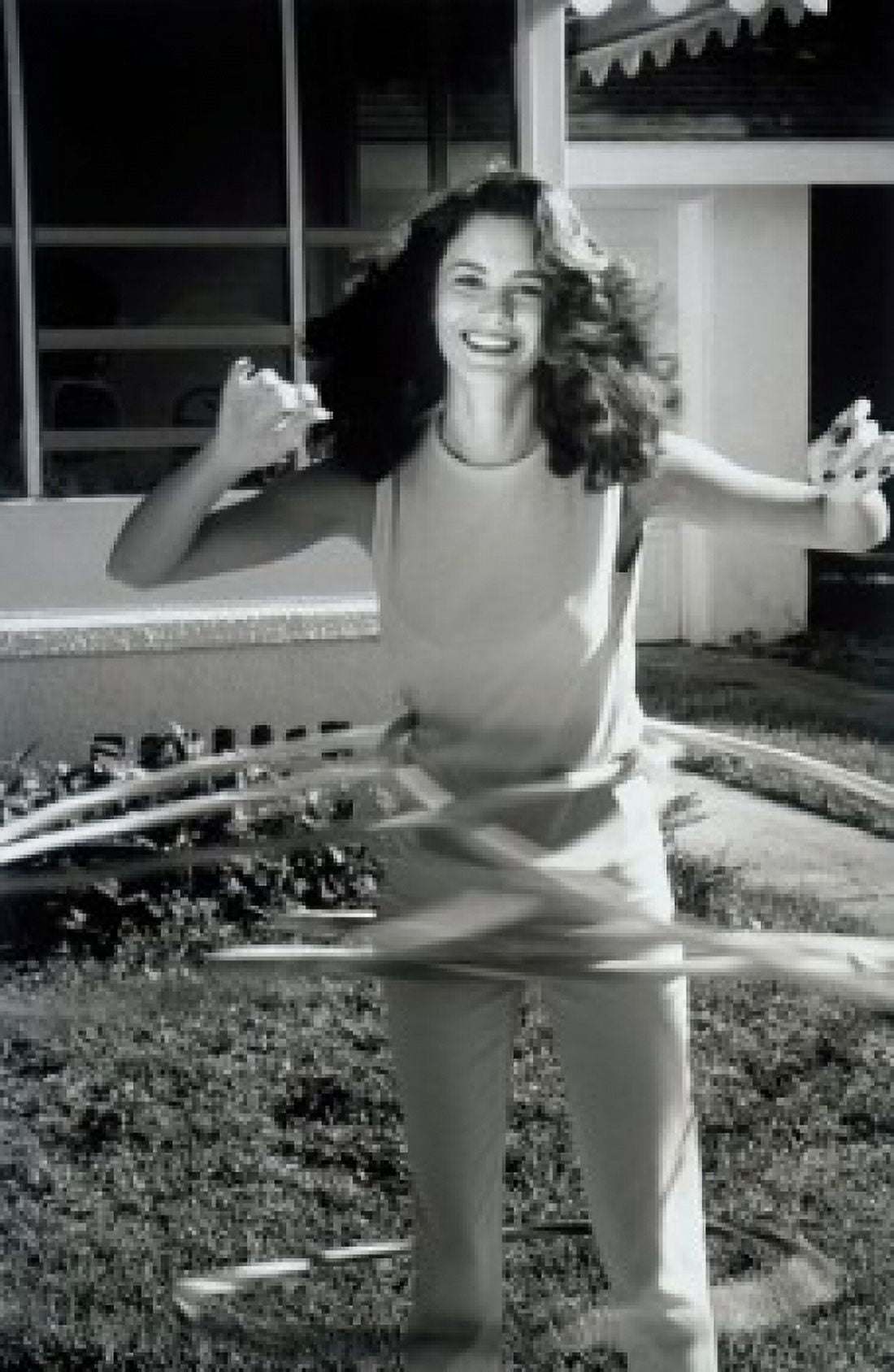 Portrait of young woman playing with hula hoops Canvas Art - (18 x 24)