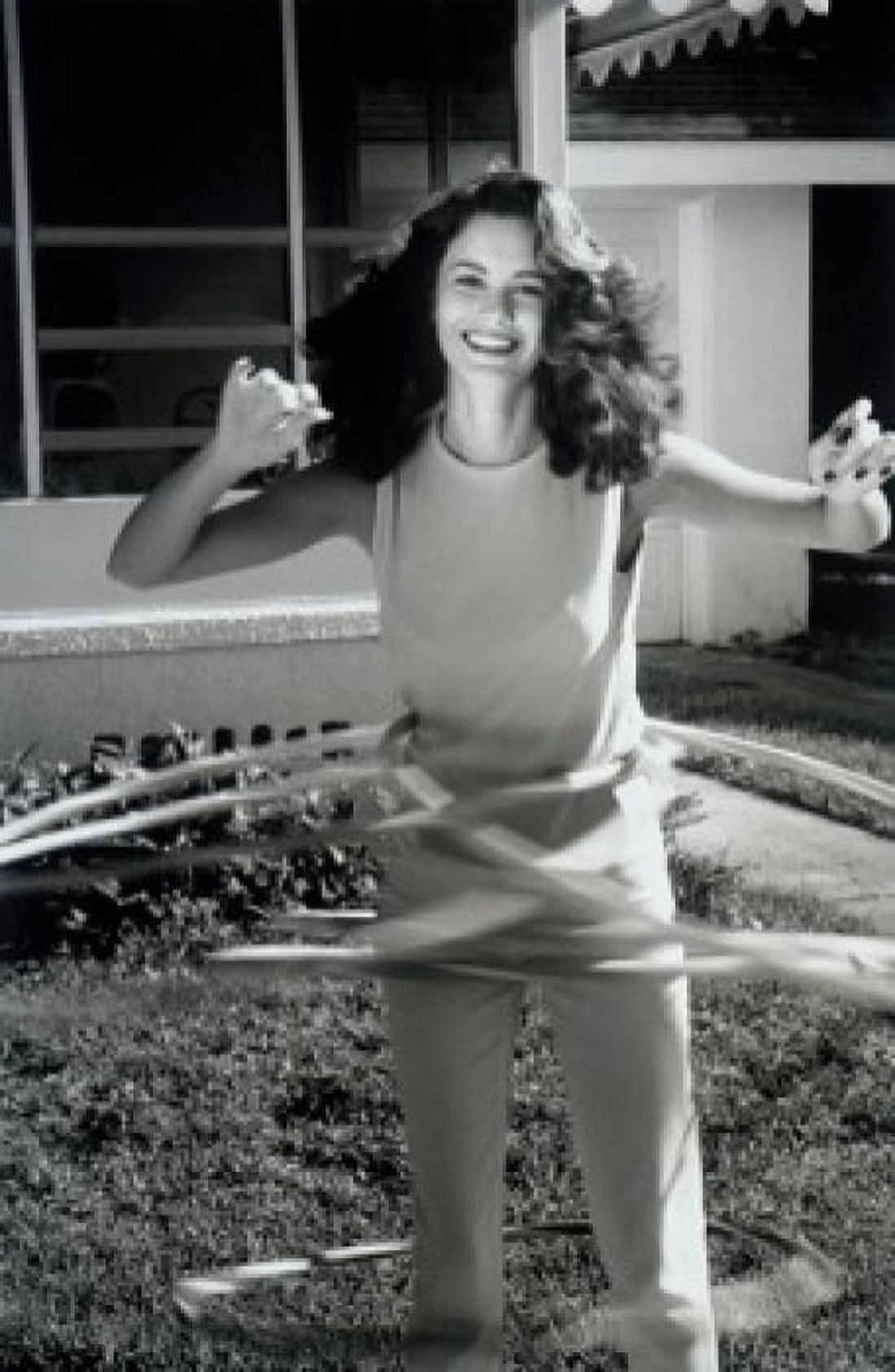Portrait of young woman playing with hula hoops Canvas Art - (24 x 36)