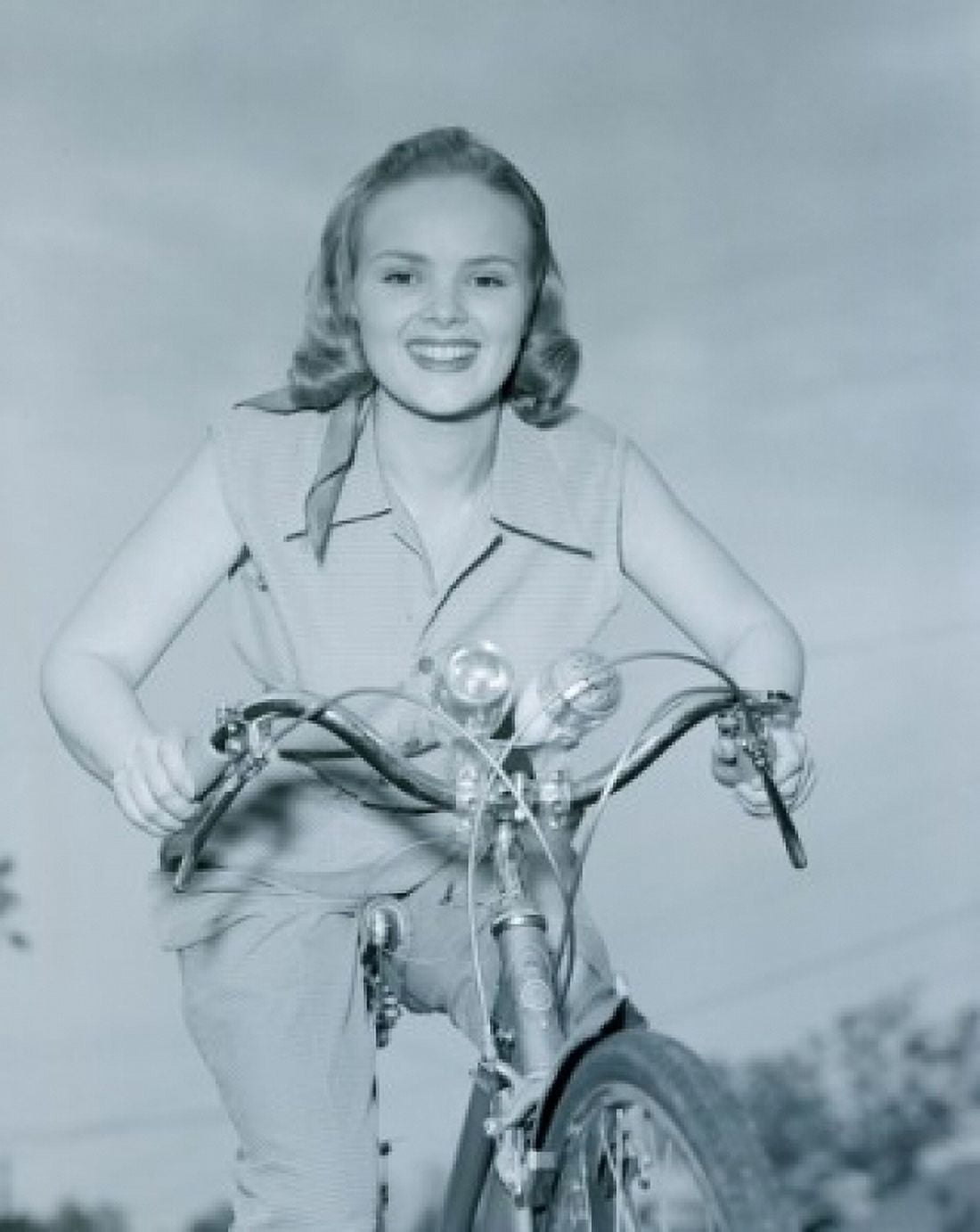 Portrait of young woman riding bike outdoors Canvas Art - (24 x 36)