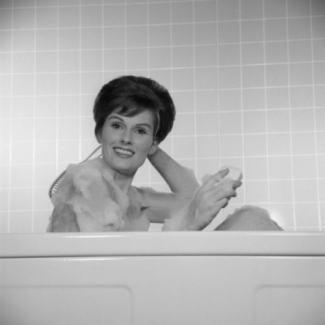 Portrait of young woman scrubbing back in bath Canvas Art - (18 x 24)