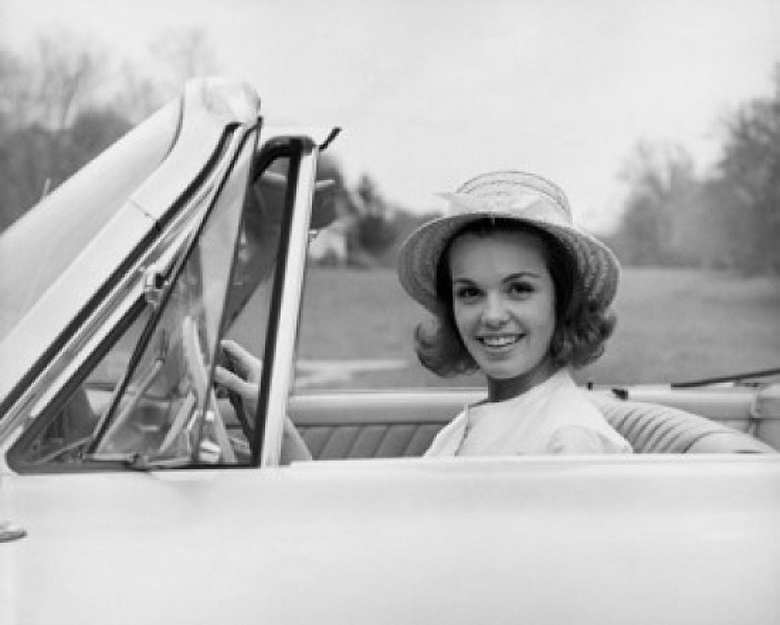 Portrait of young woman sitting in car smiling Canvas Art - (18 x 24)