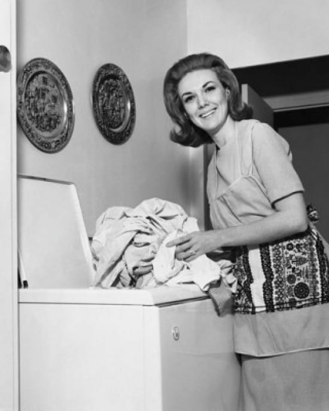 Portrait of young woman taking clothes out of washing machine Canvas Art - (24 x 36)