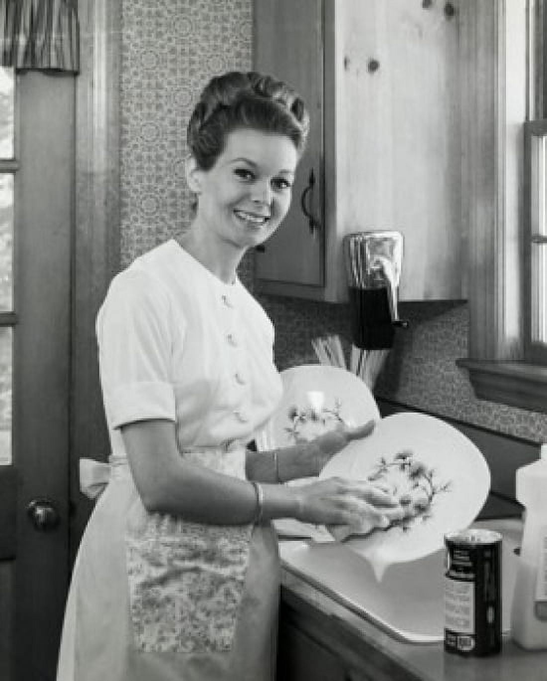 Portrait of young woman washing dishes in kitchen Canvas Art - (18 x 24)