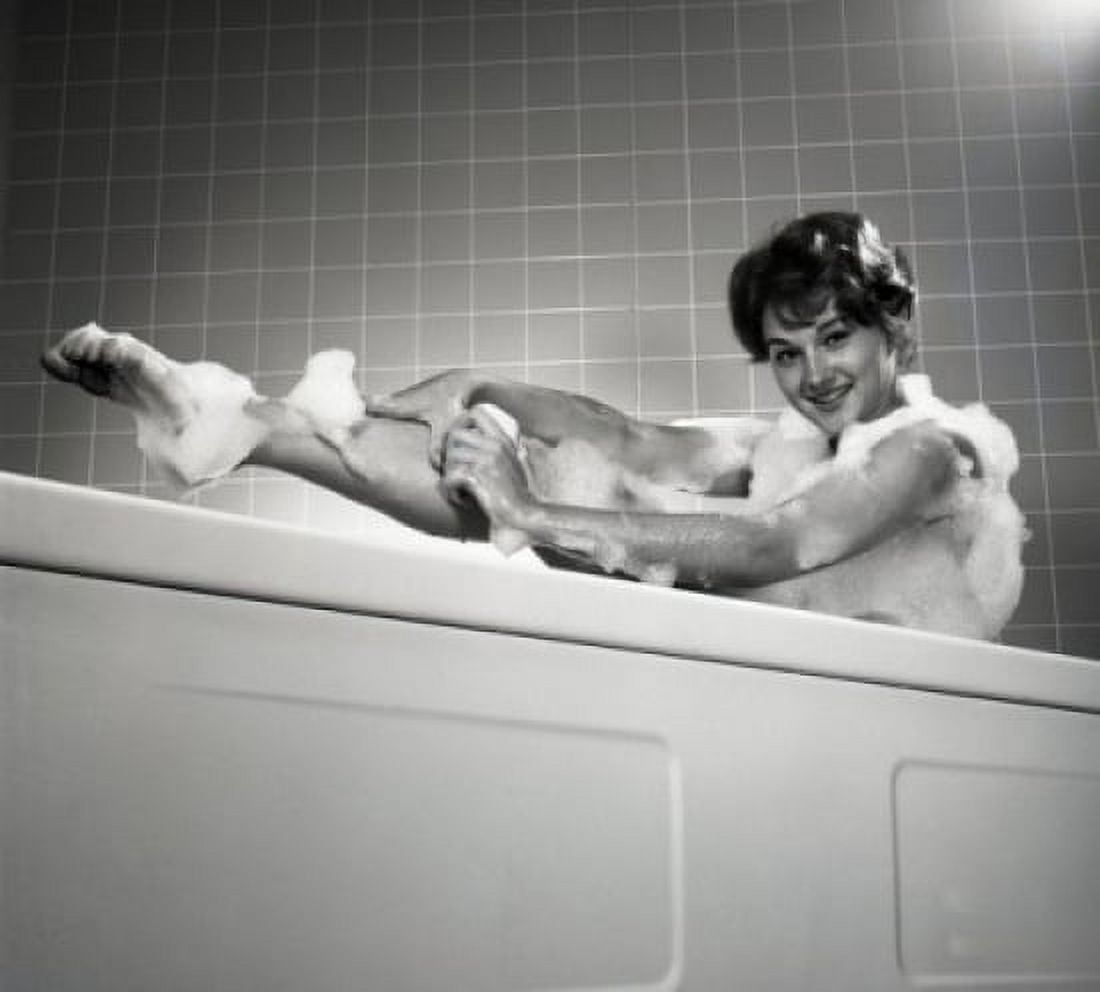 Portrait of young woman washing leg in bath Canvas Art - (18 x 24)