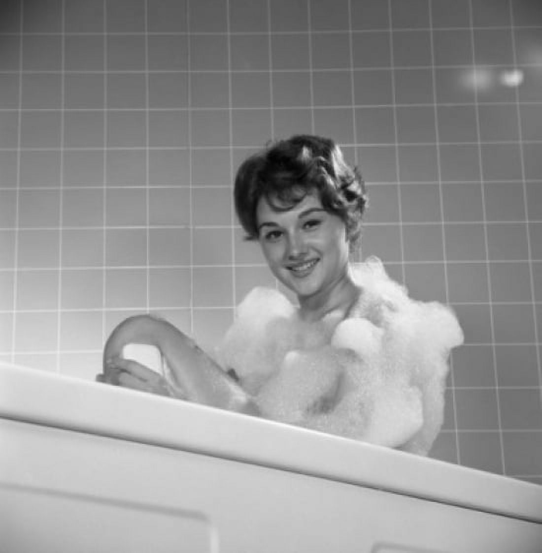 Portrait of young woman washing leg in bath Canvas Art - (24 x 36)