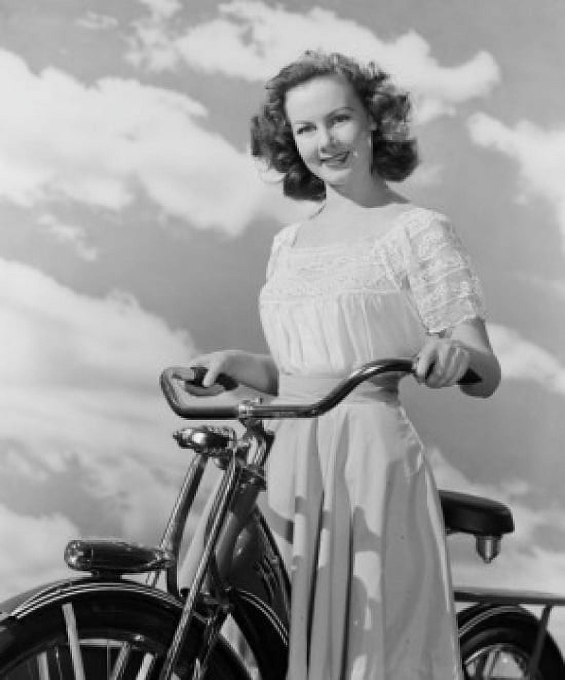 Portrait of young woman with bicycle against cloudy sky Canvas Art - (18 x 24)