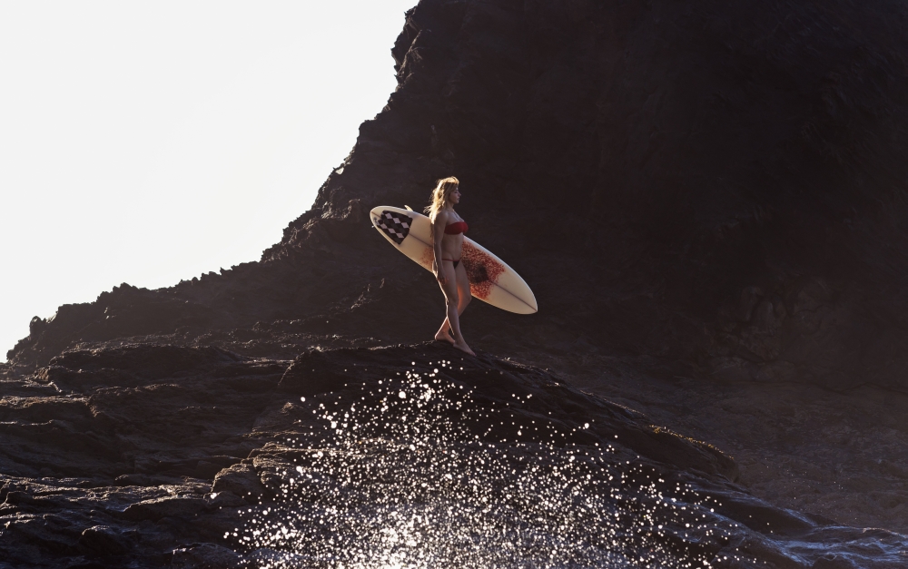 Portugal Algarve Carrapateira Distant View Of Female Surfer With Surfboard Standing On Rock Playa Do Amado Canvas Art - Ben Welsh  Design Pics (38 x 24)