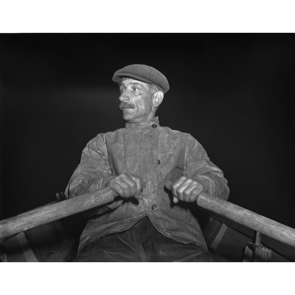 Portuguese Dory Fisherman Rowing Out To His Boat At 4 30 In The Morning For The Fishing Banks Off Cape Cod. 1942.