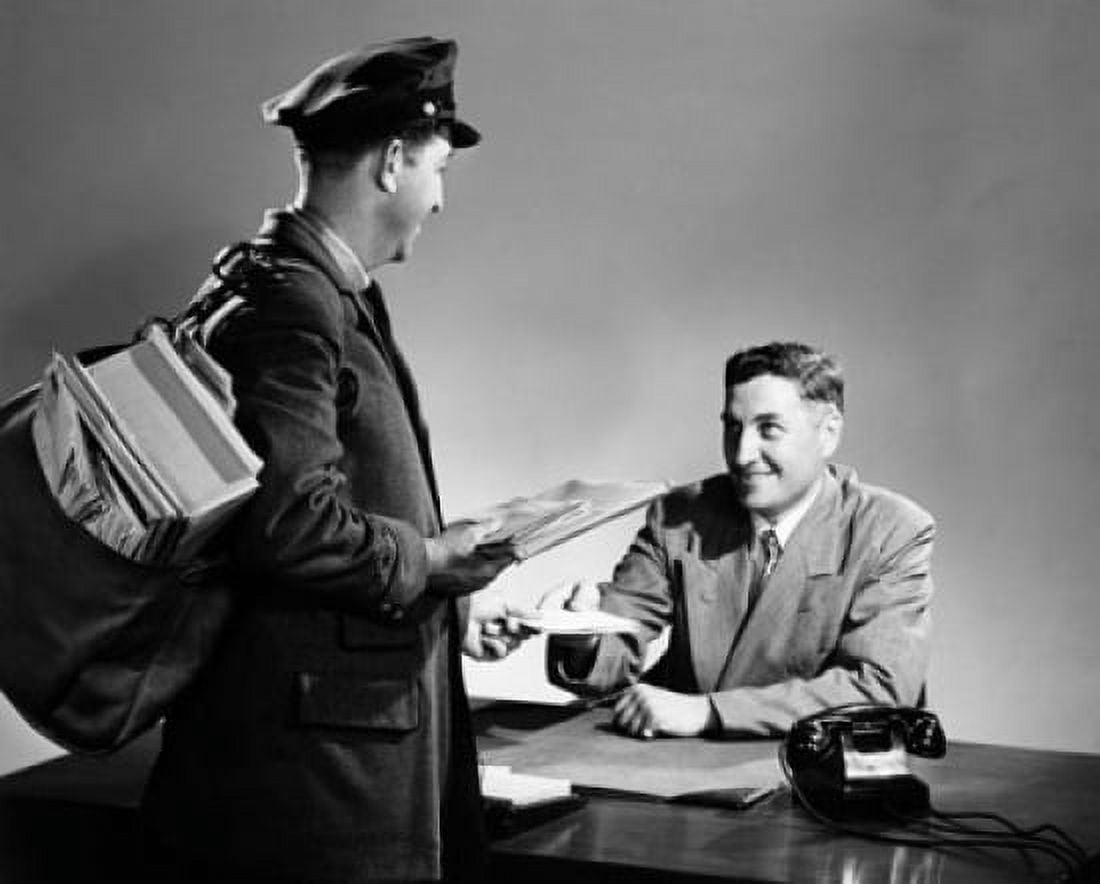 Postal worker delivering mail to a mid adult man sitting at a desk Canvas Art - (24 x 36)