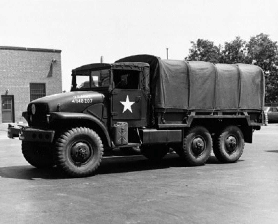 Posterazzi Army truck parked in front of a building US Military Canvas Art - (24 x 36)
