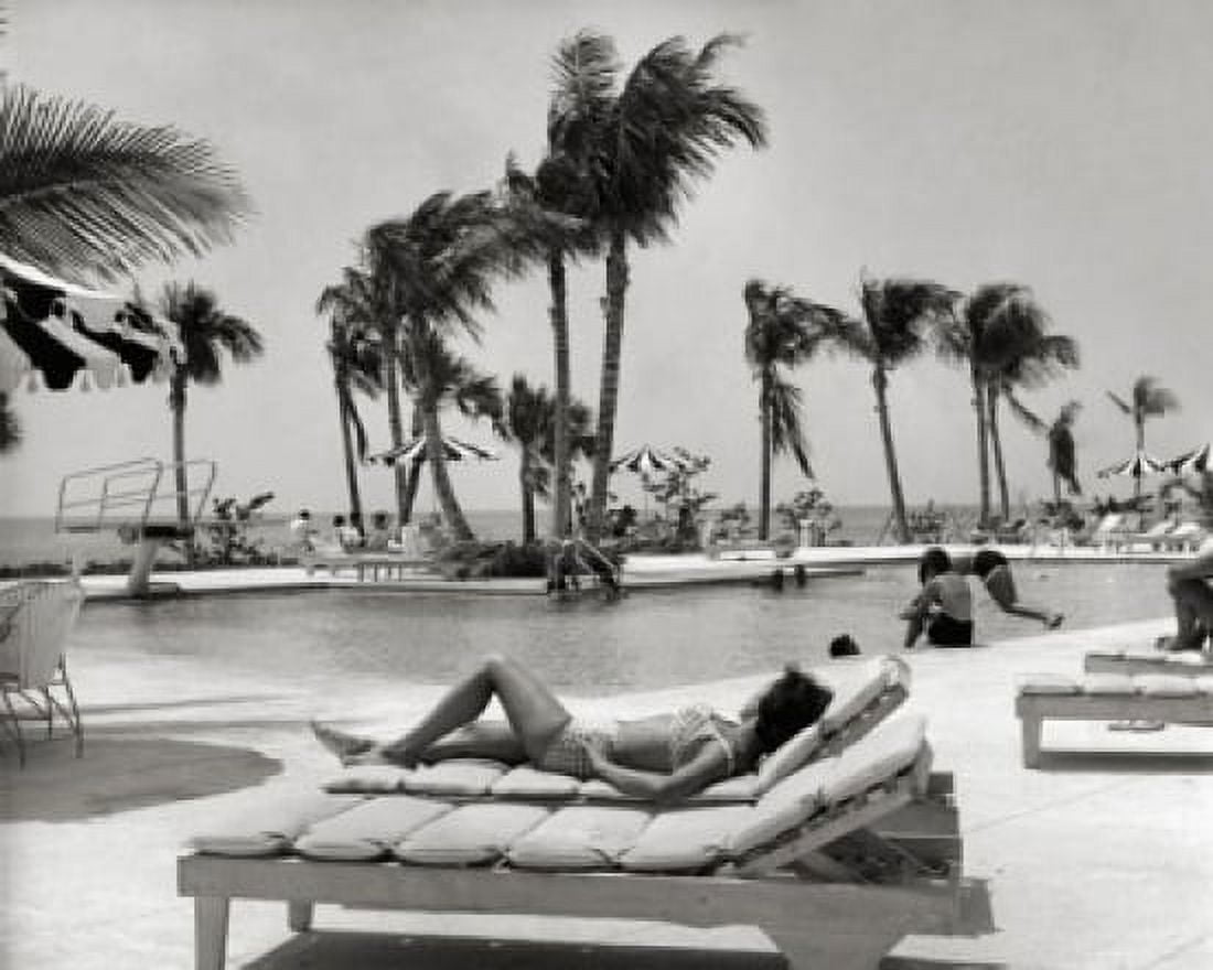 Posterazzi Bahamas young woman lying on lounge chair at poolside Canvas Art - (24 x 36)