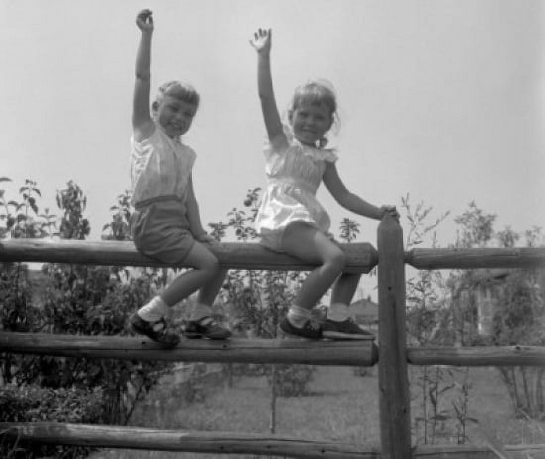 Posterazzi Boy and girl seating on split rail fence waving Canvas Art -  (24 x 36)