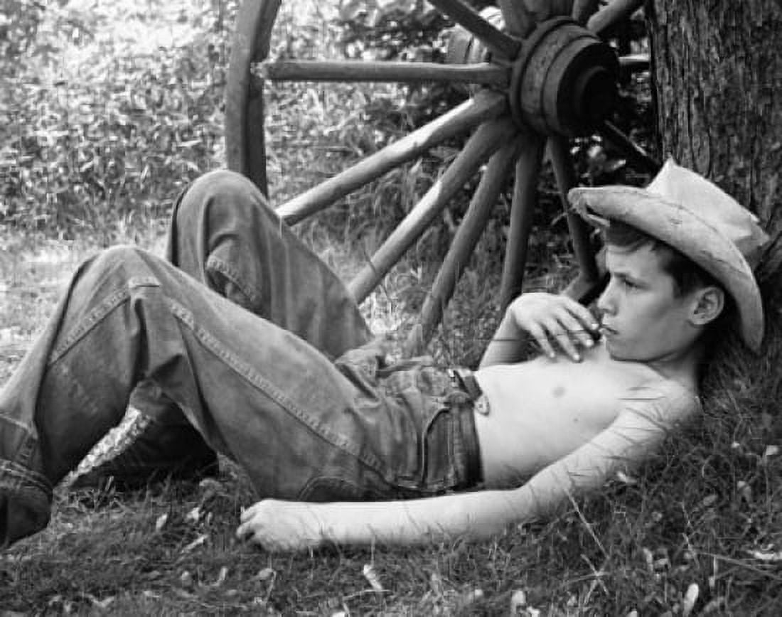 Posterazzi Boy lying near a wagon wheel Canvas Art - (24 x 36)