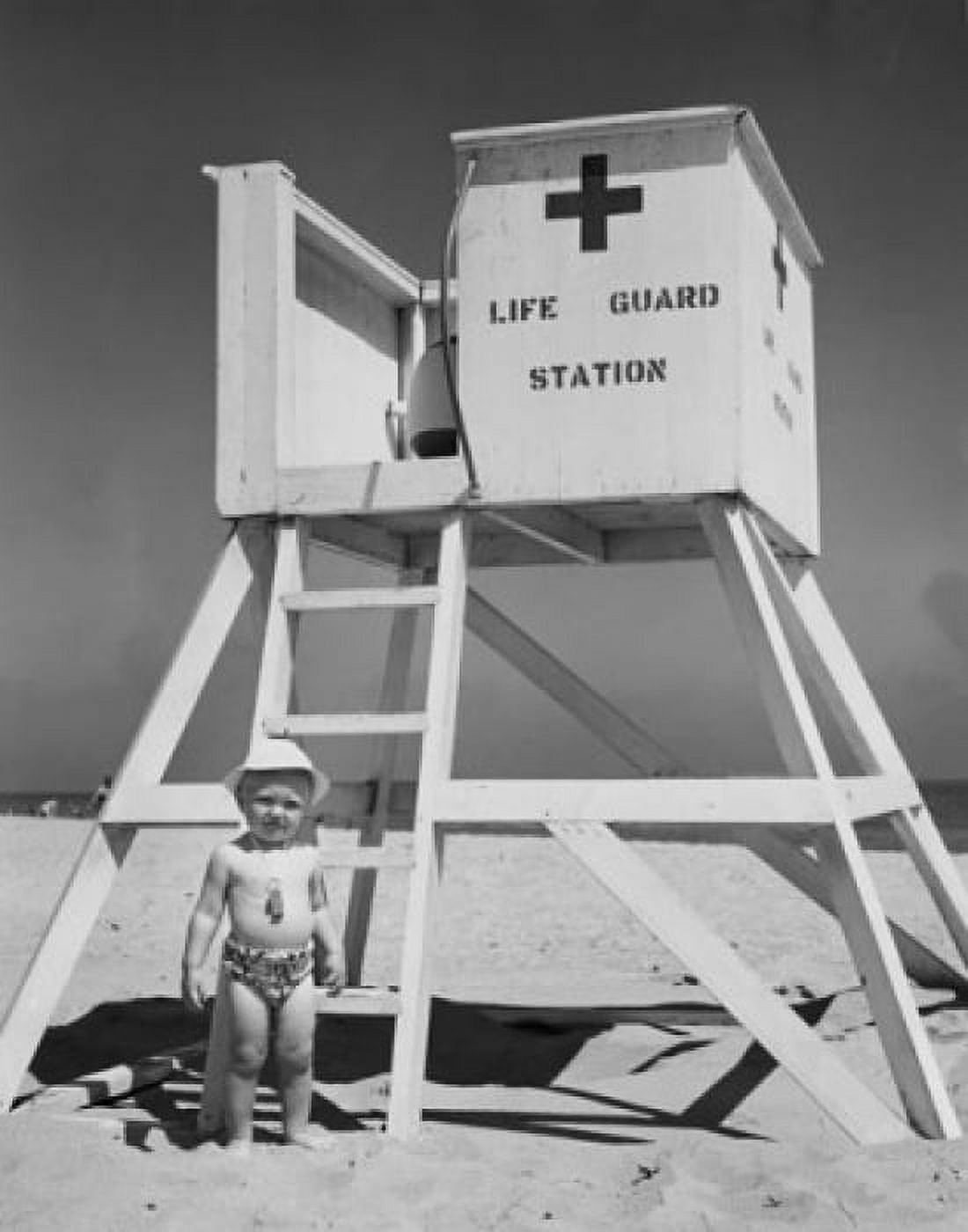 Posterazzi Boy standing near a lifeguards chair Canvas Art - (24 x 36)