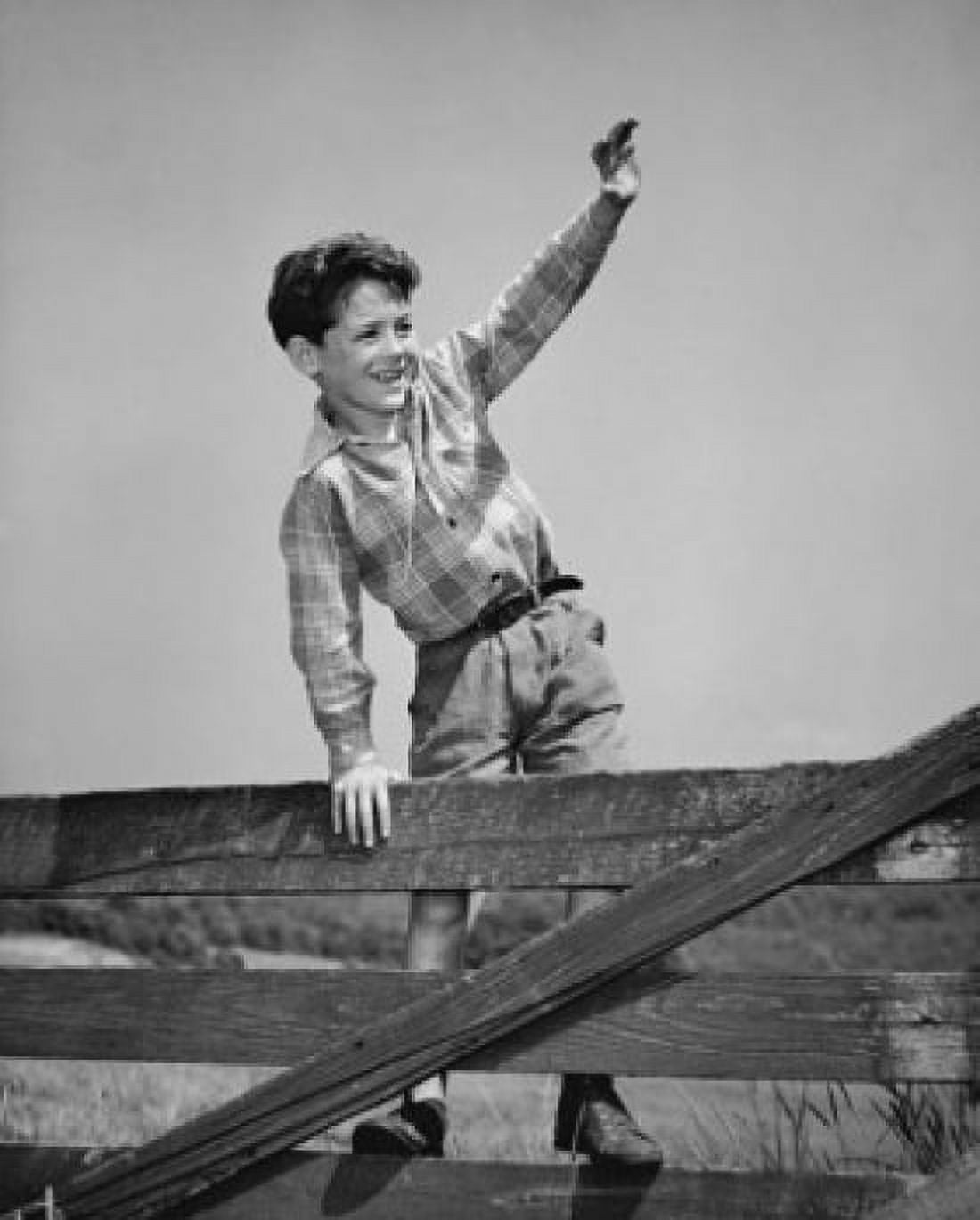 Posterazzi Boy standing on fence waving Canvas Art - (24 x 36)
