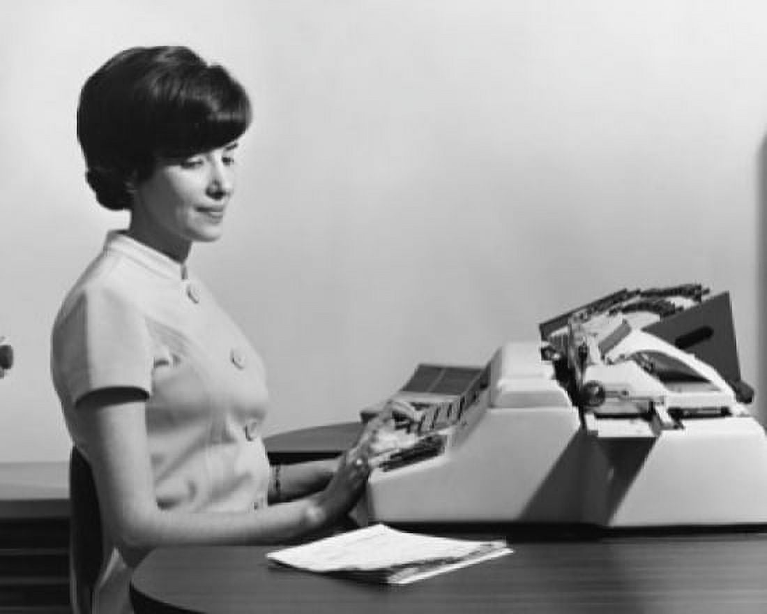 Posterazzi Businesswoman typing on a typewriter in an office Canvas Art - (24 x 36)